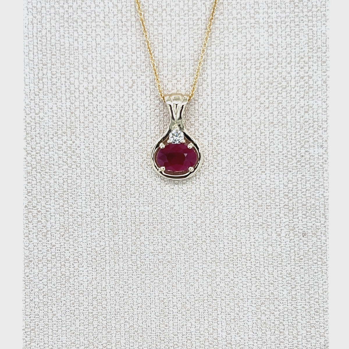 Load video: 9ct Yellow Gold Oval Ruby and Diamond Pendant